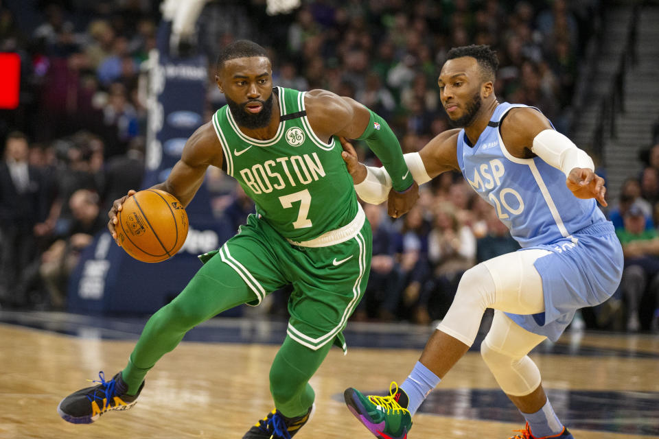 Boston Celtics guard Jaylen Brown (7) drives against Minnesota Timberwolves guard Josh Okogie (20) in the second quarter of an NBA basketball game Friday, Feb. 21, 2020, in Minneapolis. (AP Photo/Andy Clayton-King)