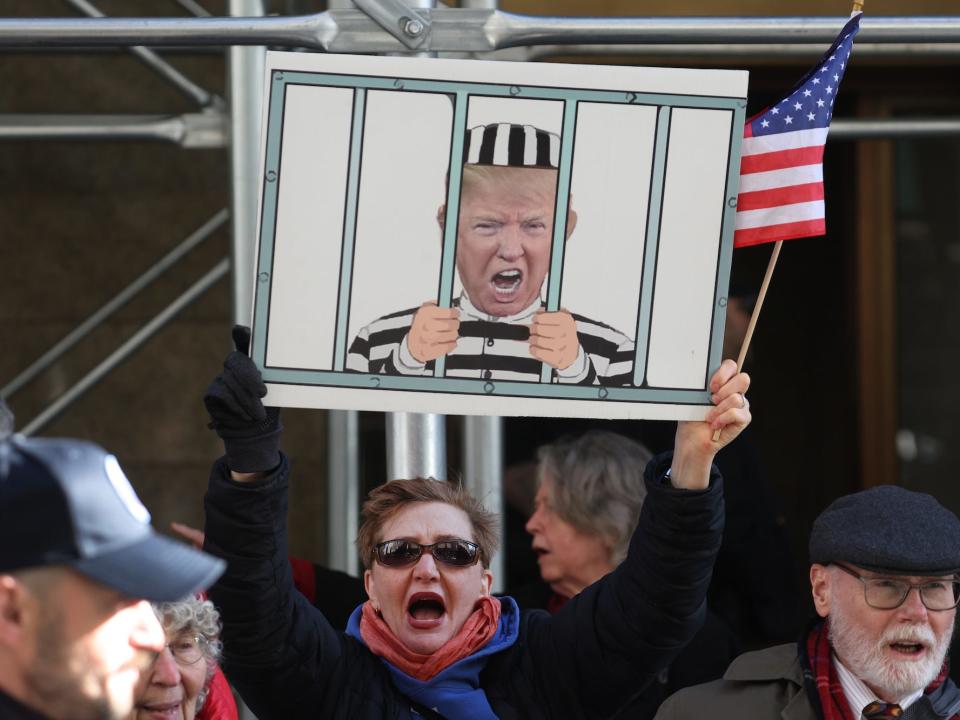 Demonstrators gather outside of Manhattan Criminal Court as a grand jury is expected to vote this week on whether to indict former US President Donald Trump on March 21, 2023 in New York City.