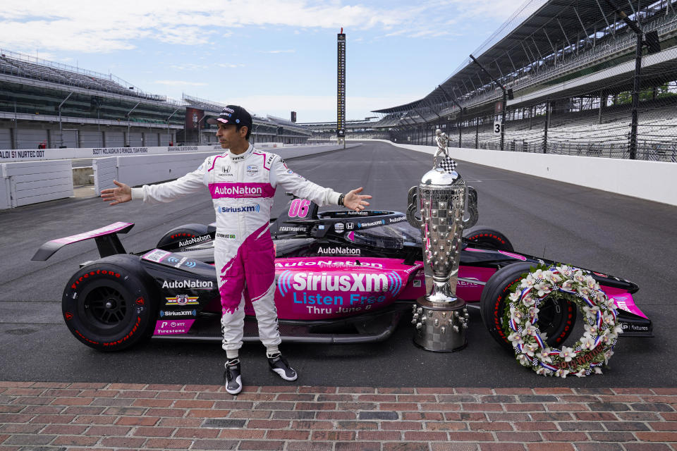 Helio Castroneves of Brazil, winner of the 2021 Indianapolis 500 auto race, poses during the traditional winners photo session at the Indianapolis Motor Speedway in Indianapolis, Monday, May 31, 2021. (AP Photo/Michael Conroy)