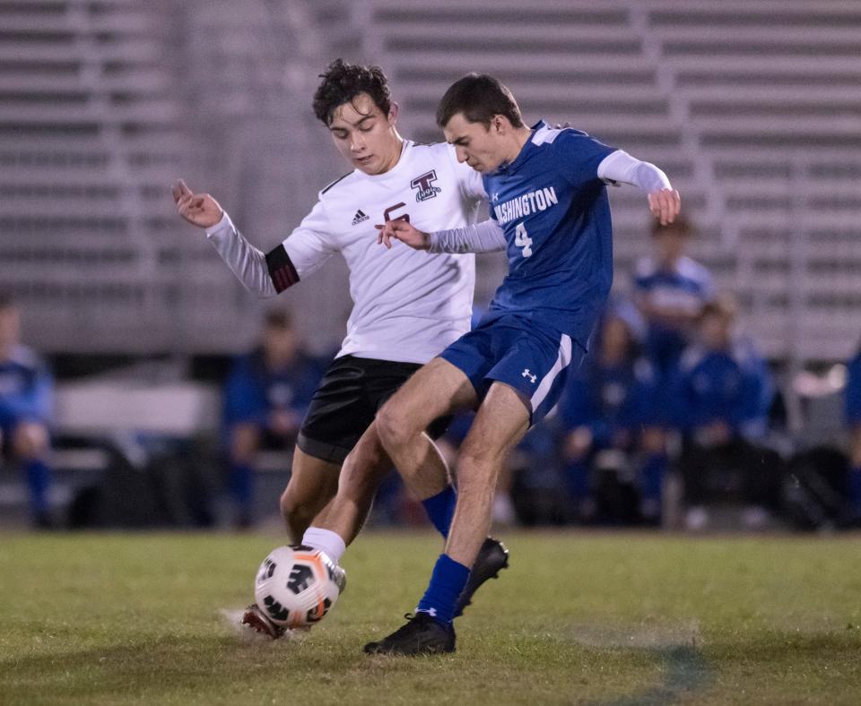 Chase Mills (6) gets off the pass as Sawyer  Kuba (4) tries to steal the ball during the Tate vs Washington boys soccer game at Booker T. Washington High School in Pensacola on Thursday, Jan. 13, 2022.