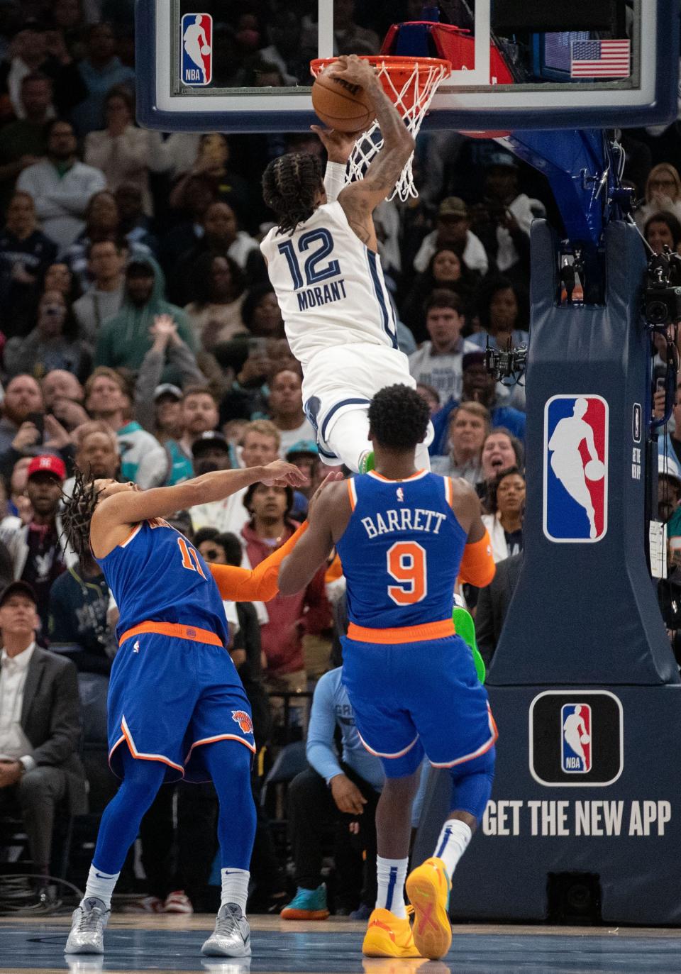 Memphis Grizzlies guard Ja Morant (12) attempts to score during the end of the second half of a game as New York Knicks guard Jalen Brunson (11) and guard RJ Barrett (9) guard him Wednesday, Oct. 19, 2022, at FedExForum. The Memphis Grizzlies defeated the New York Knicks 115-112.