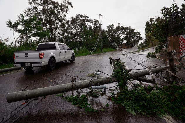 Downed power lines lie on a road in Cayey, Puerto Rico, as the island awoke to a general power outage on Monday. (Photo: Jose Jimenez via Getty Images)