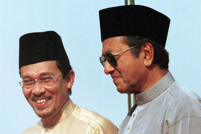 FILE - Then Deputy Prime Minister Anwar Ibrahim, left, stands next to Malaysia's Prime Minister Mahathir Mohamad during the UMNO Annual Meeting in Kuala Lumpur, Malaysia, June 20, 1998. Malaysia's king on Thursday, Nov. 24, 2022, named Anwar as the country's prime minister, ending days of uncertainties after divisive general elections produced a hung Parliament. (AP Photo/Vincent Thian, File)
