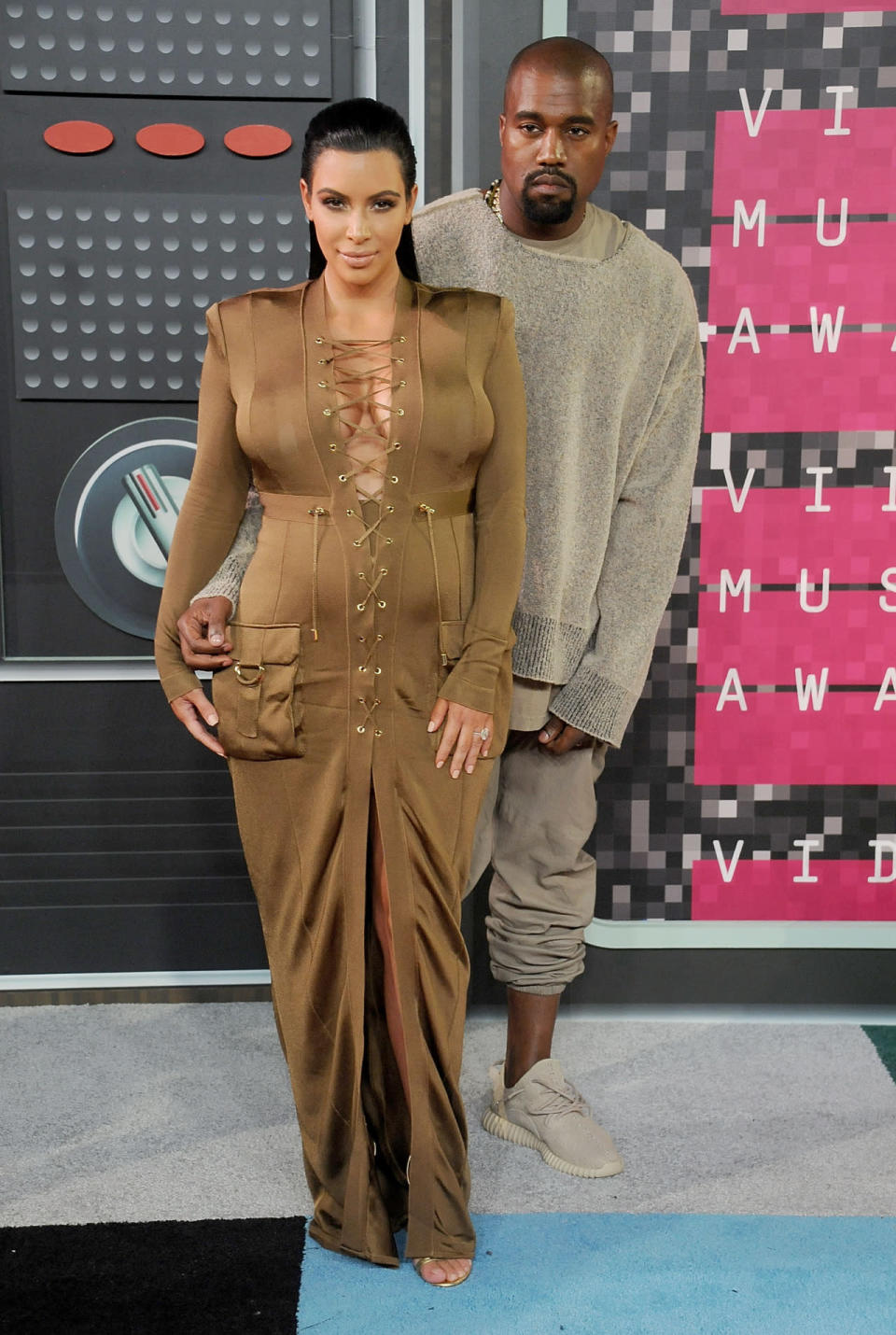 Hubby in tow, Kim Kardashian attended the VMAs in, yep you guessed it, another Balmain dress. The pregnant reality star showed off her curves in the lace-up frock and slicked back her long locks. [Photo: Getty]