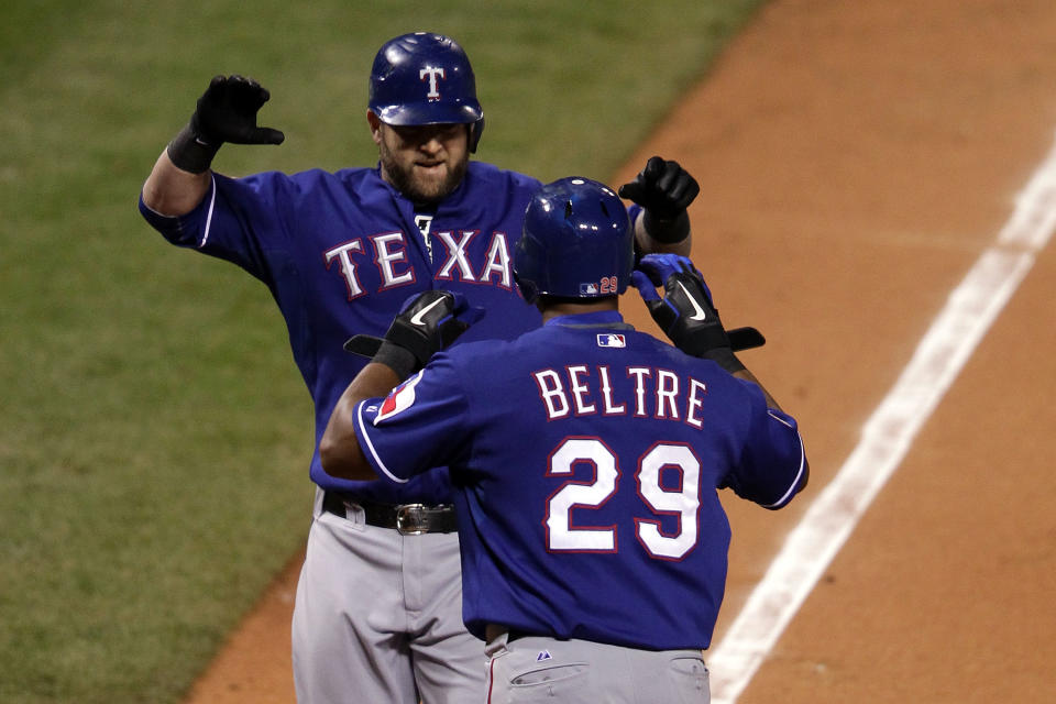 ST LOUIS, MO - OCTOBER 19: Mike Napoli #25 and Adrian Beltre #29 of the Texas Rangers celebrate after Napoli hit a two-run homerun in the top of the fifth inning during Game One of the MLB World Series against the St. Louis Cardinals at Busch Stadium on October 19, 2011 in St Louis, Missouri. (Photo by Doug Pensinger/Getty Images)