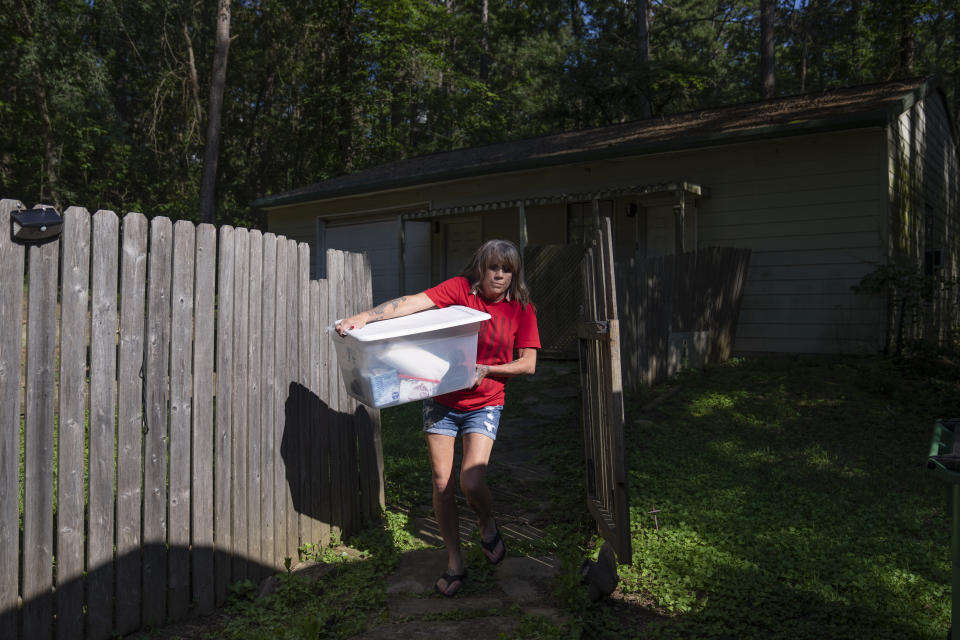 Barbie Rohde loads up merchandise at her home in Flint, Texas, Friday, June 9, 2023, to sell at a festival as part of her volunteer work for Mission 22. The nonprofit is focused on ending military and veteran suicide, which kills thousands of service members every year, including her 25-year-old son, Army Sgt. Cody Bowman. (AP Photo/David Goldman)