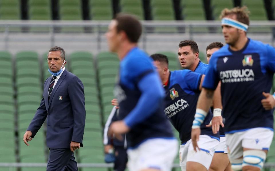 Italy's Head Coach Franco Smith (L) watches his players warm up during the Six Nations international rugby union match between Ireland and Italy at the Aviva Stadium in Dublin, on October 24, 2020. - AFP