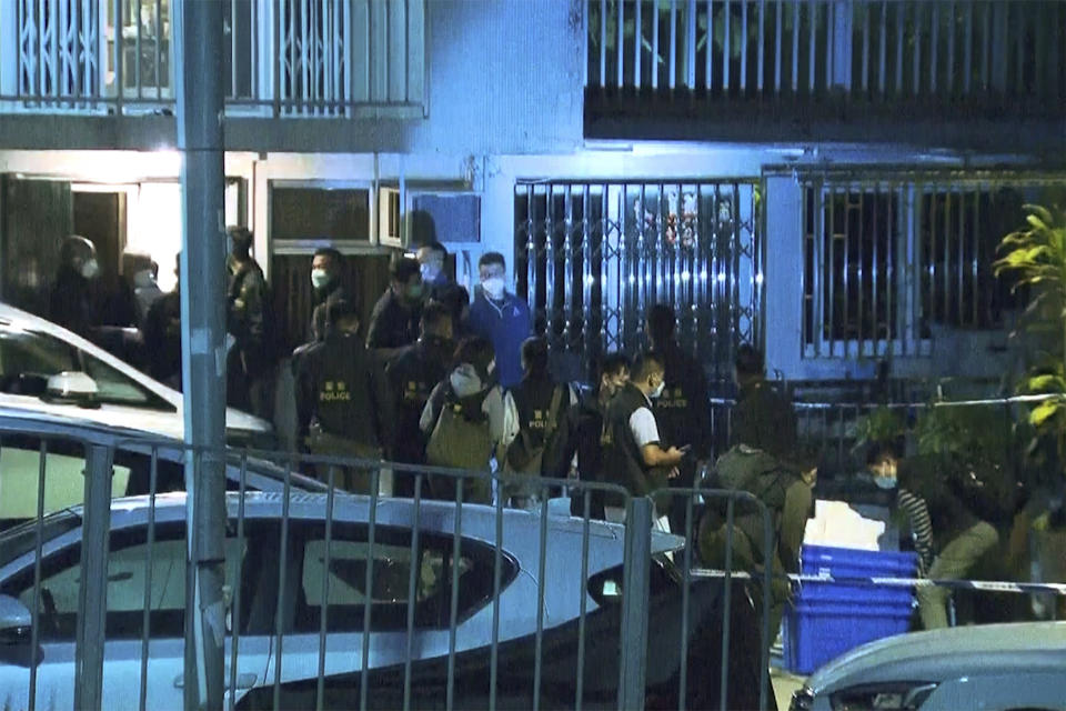 In this image taken from video footage provided by TVB Hong Kong, police officers search a village home where they found body parts related to a missing model in a murder case, in Hong Kong on Sunday, Feb. 26, 2023. Police in Hong Kong have filed murder charges against the former in-laws of a model, days after her body parts were found in a refrigerator. A police statement says Hong Kong model Abby Choi’s father-in-law and his eldest son are being charged with murder, while her mother-in-law faces one count of perverting the course of justice. (TVB Hong Kong via AP)