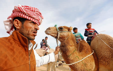 Jockeys, most of whom are children, wait at the starting line at the 18th International Camel Racing festival at the Sarabium desert in Ismailia, Egypt, March 12, 2019. Picture taken March 12, 2019. REUTERS/Amr Abdallah Dalsh