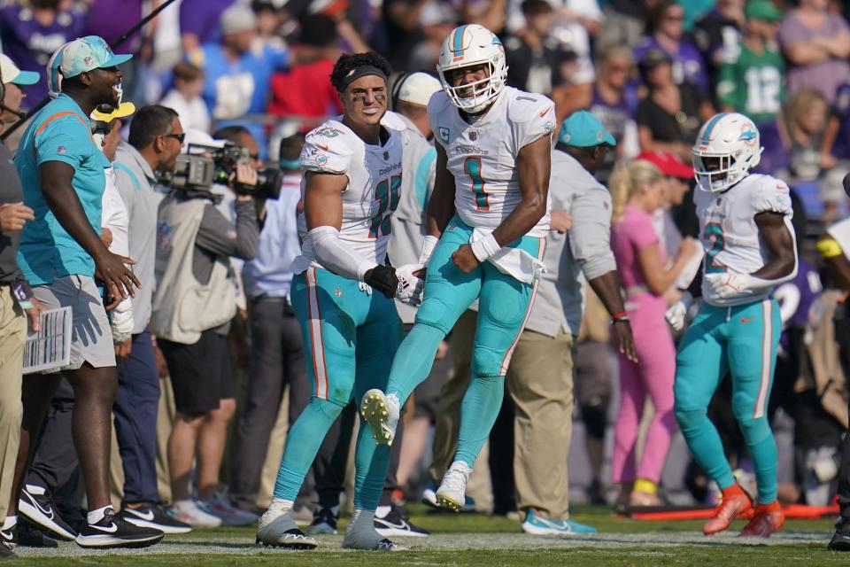 Dolphins quarterback Tua Tagovailoa (1) celebrates after throwing a touchdown pass to Jaylen Waddle during the second half of Sunday's  win over the Ravens.