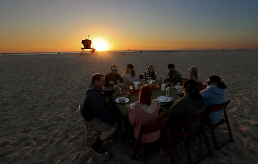 HUNTINGTON BEACH, CA. - NOV. 25, 2020. Members of the Hobbs-Brown family celebrate Thanksgiving dinner on the sand at Bolsa Chica State Beach on Wednesday, Nov. 25, 2020. (Luis Sinco/Los Angeles Times)