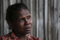 In this Oct. 21, 2018, photo, Yohanna Banunaek, cries as she talks about her late daughter Adelina Sau, in Abi village in West Timor, Indonesia. Sau had been working as a maid for a Malaysian family when a local lawmaker's office received a tip from neighbors who suspected she was being abused. An autopsy determined she died of septicemia and cited possible abuse and neglect. (AP Photo/Tatan Syuflana)