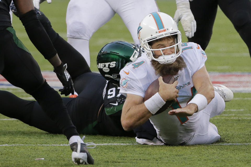 Miami Dolphins quarterback Ryan Fitzpatrick (14) is tackled by New York Jets defensive end Nathan Shepherd (97) during the fourth quarter of an NFL football game, Sunday, Dec. 8, 2019, in East Rutherford, N.J. (AP Photo/Seth Wenig)