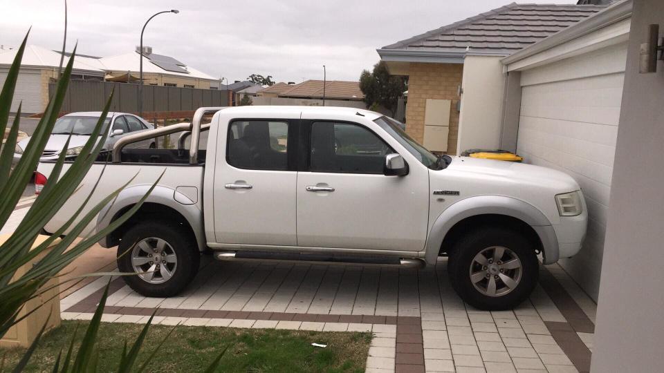 Perth woman Courtney was fined because the back of her car tipped over the edge of her driveway. Source: Supplied