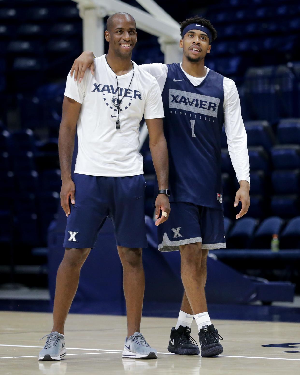 Xavier Musketeers assistant coach Dante Jackson, left), and Xavier Musketeers guard Paul Scruggs (1), right, share a laugh during practice, Wednesday, July 17, 2019, at Cintas Center in Cincinnati. 