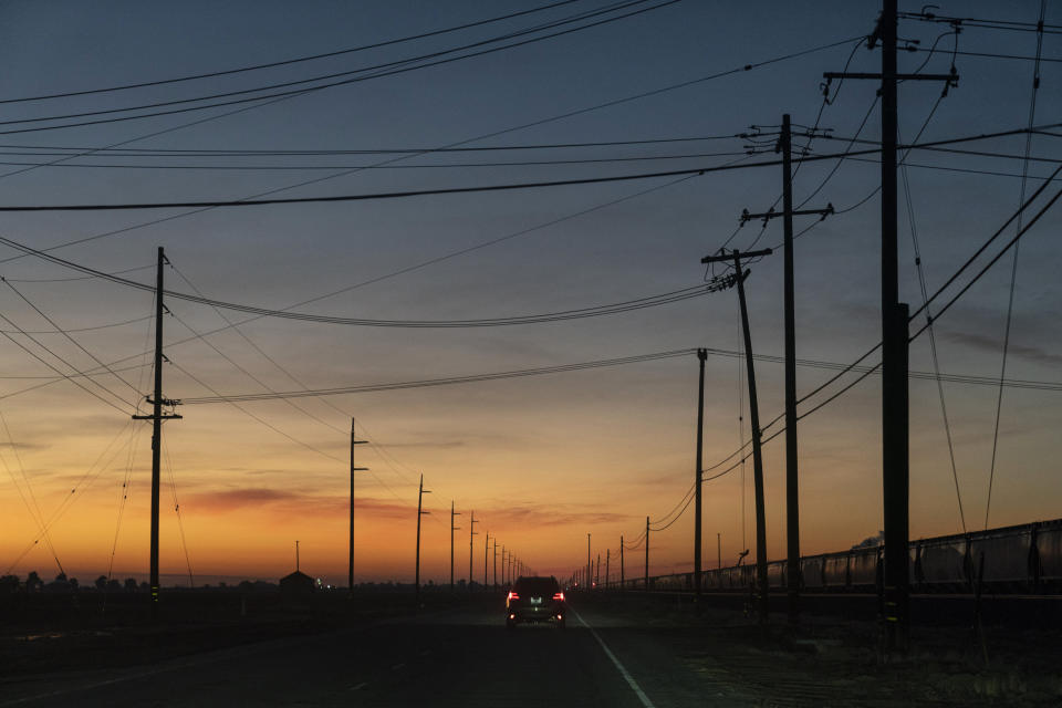 Vehicles carrying the crew members of Quiet and Anti-Recidivism Coalition (ARC) head toward Valley State Prison early in the morning for a special film tour in Chowchilla, Calif., Friday, Nov. 4, 2022. In a nation that incarcerates roughly 2 million people, the COVID pandemic was a nightmare for prisons. Overcrowding, subpar medical care and the ebb and flow of prison populations left most places unprepared to handle the spread of the highly contagious virus. (AP Photo/Jae C. Hong)