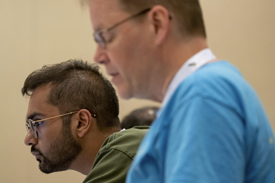Sameer Mishra, left, and Pronouncer Jacques Bailly attend a word panel meeting to finalize the 2023 Scripps National Spelling Bee words on Sunday, May 28, 2023, at National Harbor in Oxon Hill, Md. (AP Photo/Nathan Howard)