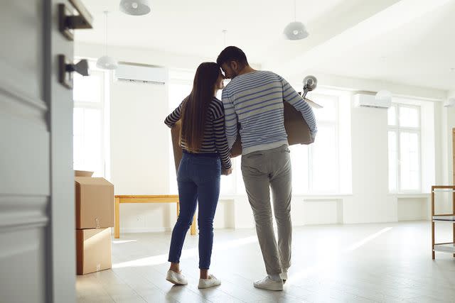 <p>Getty Images</p> Young couple moves into home