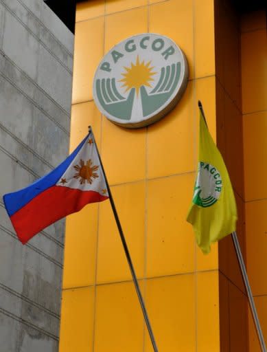 A Philippine flag flies in front of the headquarters of the government-owned Philippine Amusement and Gaming Corp. (PAGCOR) in Manila. Japanese gambling tycoon Kazuo Okada is accused of offering payments and gifts to two regulators at Pagcor