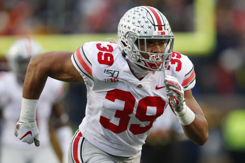 FILE - In this Nov. 30, 2019, file photo, Ohio State linebacker Malik Harrison plays against Michigan in the second half of an NCAA college football game, in Ann Arbor, Mich. Harrison believes spending a week last month at the Senior Bowl set him up for an even better performance at this week's NFL's annual scouting combine. To Harrison and dozens of others who took advantage of an extra week on the football field last month, they believe it was well worth the risk. (AP Photo/Paul Sancya, File)