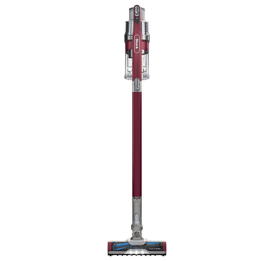 A red Skark stick-style vaccuum