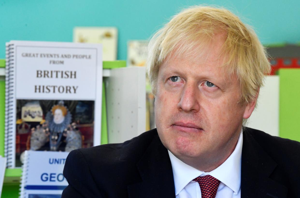 Britain's Prime Minister Boris Johnson speaks with year four and year six pupils during a visit to Pimlico Primary school in London