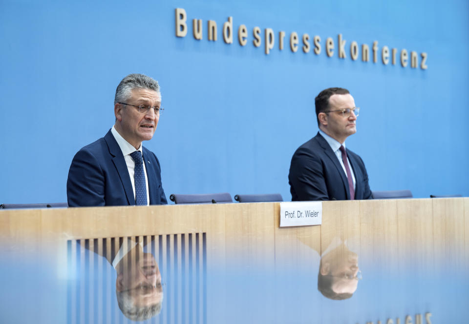 Acting German Health Minister Jens Spahn and Lothar H. Wieler, President of Germany's disease control agency Robert Koch Institute brief the media on the current situation of the coronavirus pandemic in Berlin, Germany, Friday, Nov. 26, 2021. (Bernd von Jutrczenka/dpa via AP)