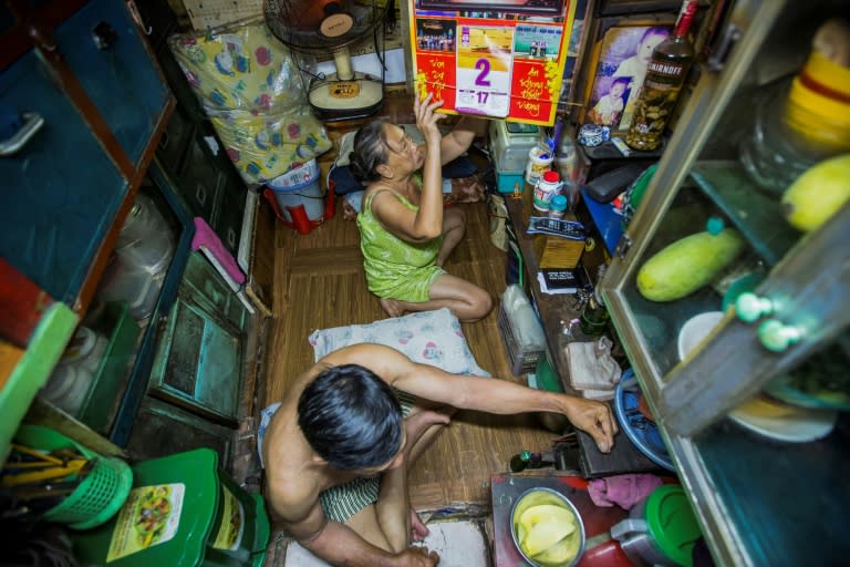 Kha Tu Ngoc and her husband Pham Huy Duc prepare for dinner in their 'micro-house' in Ho Chi Minh City. In downtown districts, families cling to postage stamp-sized plots as the city develops at breakneck pace