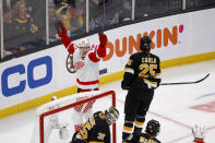 Detroit Red Wings right wing Alex Chiasson (48) reacts after scoring a goal past Boston Bruins goaltender Linus Ullmark (35) as Bruins defenseman Brandon Carlo (25) looks on during the first period of an NHL hockey game, Saturday, March 11, 2023, in Boston. (AP Photo/Mary Schwalm)