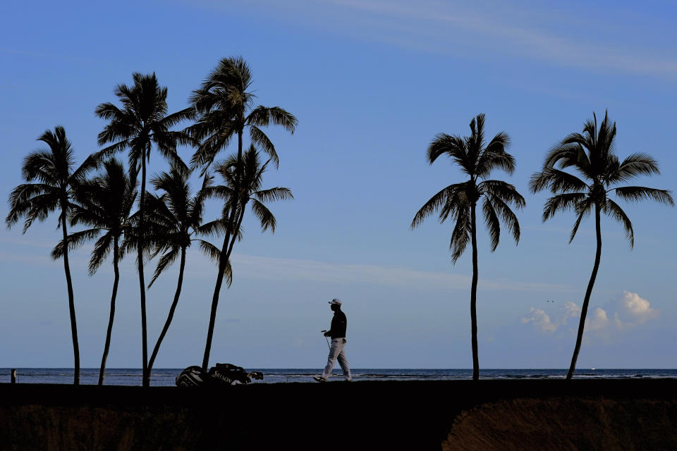 Hideki Matsuyama, of Japan, walks across the 17th green during the second round of the Sony Open golf tournament, Friday, Jan. 14, 2022, at Waialae Country Club in Honolulu. (AP Photo/Matt York)