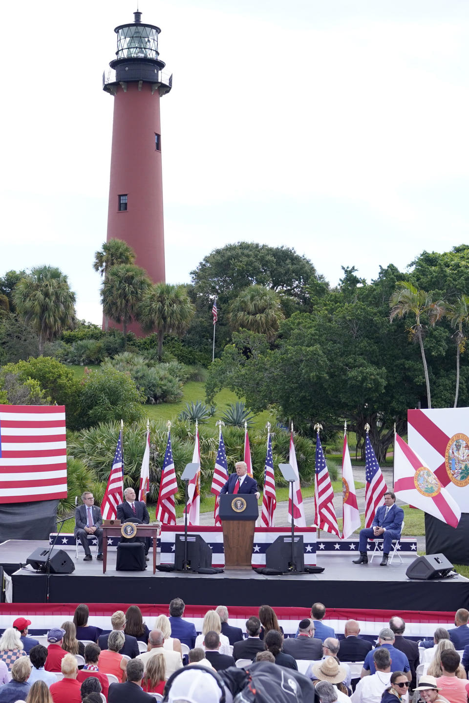 President Donald Trump, center, speaks during an event discussing environmental policies at the Jupiter Inlet Lighthouse and Museum Tuesday, Sept. 8, 2020, in Jupiter, Fla. (AP Photo/John Raoux)