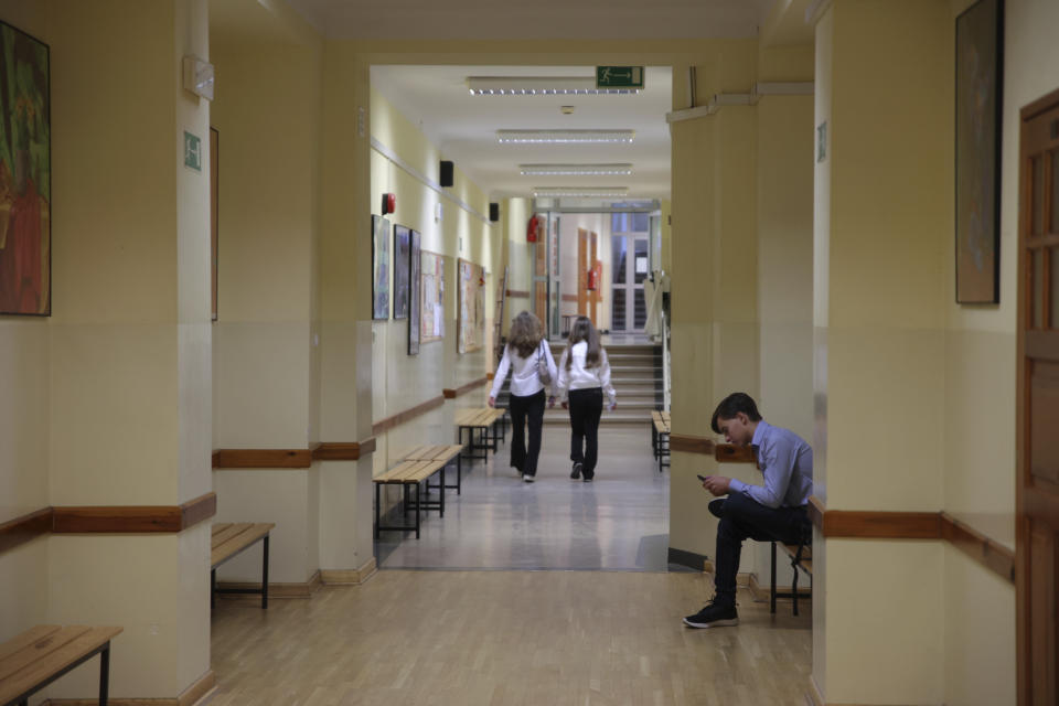 A students attends the beginning of a new school year at the Limanowski High School in Warsaw, Poland, Thursday, Sept. 1, 2022. The public schools in Poland are facing a shortage of teachers, a problem that is growing increasingly serious each year as people leave the profession over low wages and policies of a government which they fear does not value them. A teachers union and teachers say the situation threatens the education of the country's youth, though the government insists that they are exaggerating the scale of the problem. (AP Photo/Michal Dyjuk)