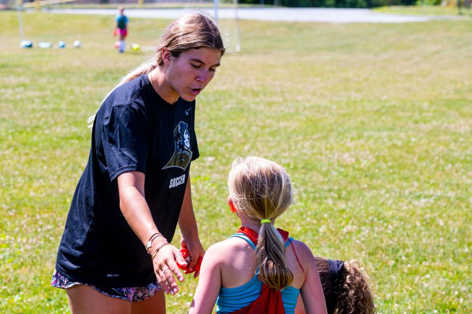 Meg Hughes works with a local youth soccer player at the  MATTREC Girls Soccer Clinic.