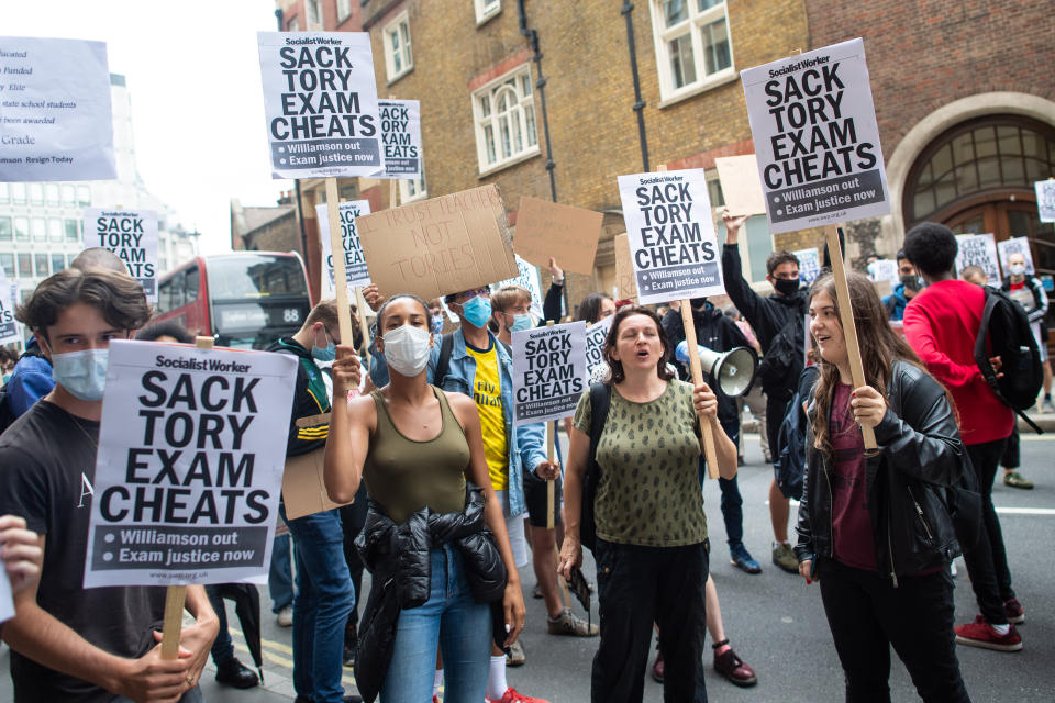 People take part in a protest marching from Downing Street to the Department of Education in Westminster, London, over the government's handling of A-level results. Thousands of pupils across England have expressed their disappointment at having their results downgraded after exams were cancelled due to coronavirus. Picture date: Friday August 14, 2020. Photo credit should read: Matt Crossick/Empics