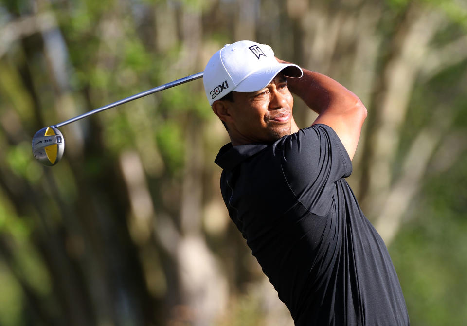 Tiger Woods plays a shot on the 13th hole during the first round of the Arnold Palmer Invitational presented by MasterCard at the Bay Hill Club and Lodge in Orlando, Florida. Woods put himself among the leaders at the Arnold Palmer Invitational on Thursday with a three-under par 69 in the opening round of his first US PGA tournament since an injury scare. (AFP Photo/Sam Greenwood)