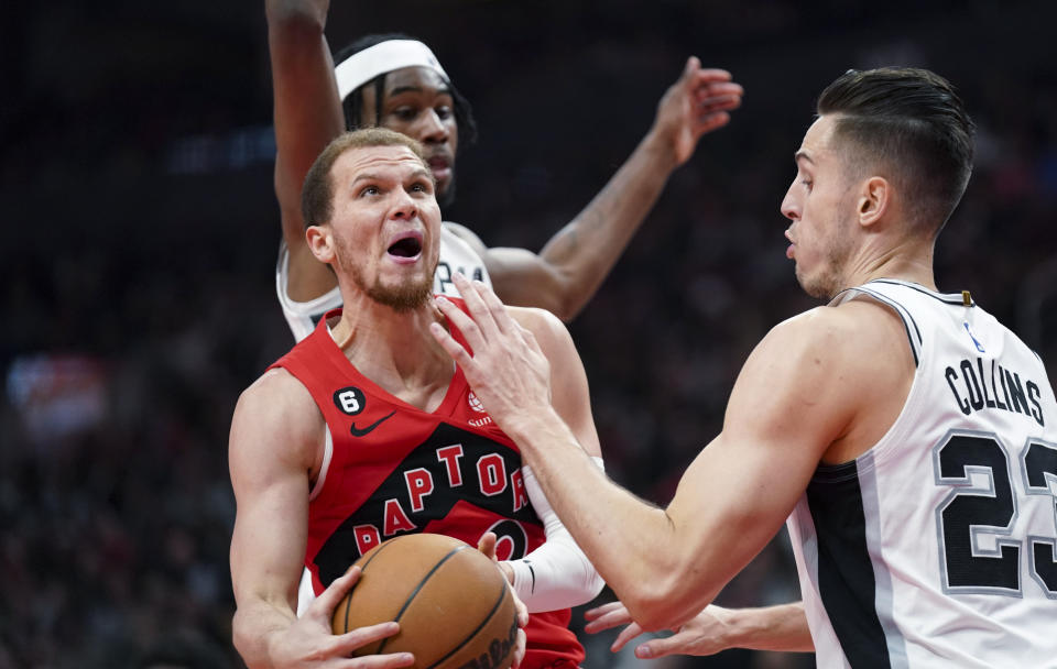 Toronto Raptors guard Malachi Flynn (22) goes for a layup against San Antonio Spurs forward Zach Collins (23) during the first half of an NBA basketball game Wednesday, Feb. 8, 2023, in Toronto. (Arlyn McAdorey/The Canadian Press via AP)