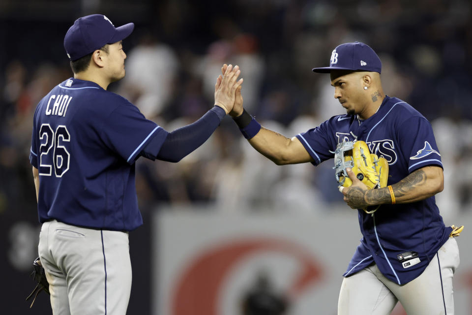 Tampa Bay Rays' Wander Franco, right, high-fives Ji-Man Choi after a baseball game against the New York Yankees, Friday, Sept. 9, 2022, in New York. (AP Photo/Adam Hunger)
