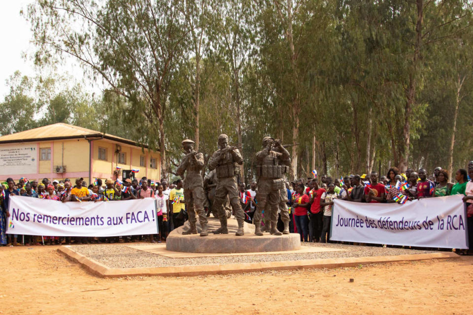 Demonstrators hold a banner reading "We thank the FACA (Armed Forces of the Central African Republic)" in Bangui on February 23, 2022 during a pro Russia demonstration held around a statue representing Central African soldiers and Russian armed men.