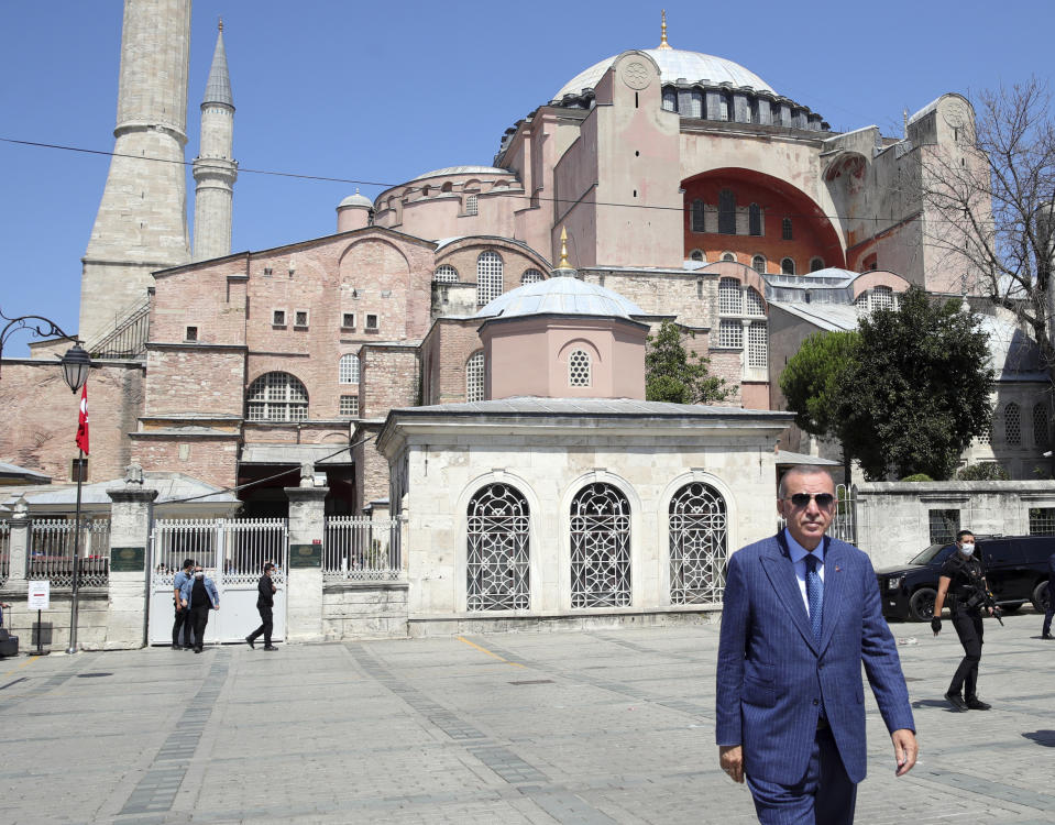 Turkey's President Recep Tayyip Erdogan arrives to speak to supporters and the media after Friday prayers in Hagia Sophia, in the background, in Istanbul, Friday, Aug. 7, 2020. Erdogan joined worshipers on July 24 for the first Muslim prayers in 86 years inside the Istanbul landmark that served as one of Christendom's most significant cathedrals, a mosque and a museum before its conversion back into a Muslim place of worship.Turkey's president has called a maritime deal between Greece and Egypt "worthless," saying Turkey will resume oil and gas exploration in the Eastern Mediterranean.(Turkish Presidency via AP, Pool)