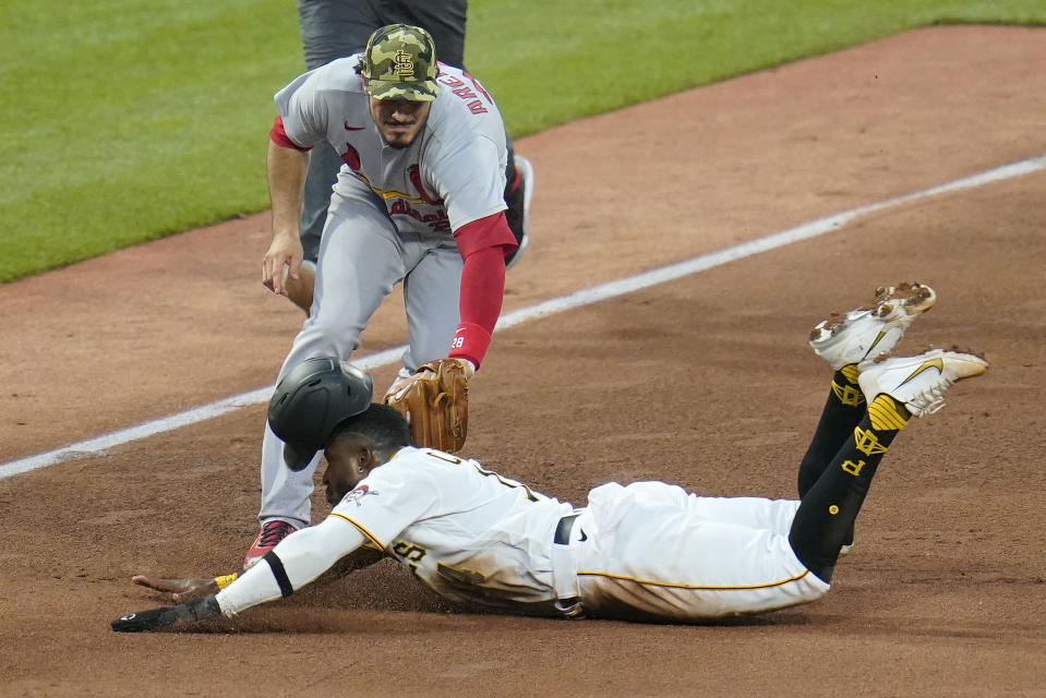 St. Louis Cardinals third baseman Nolan Arenado, top front, tags out Pittsburgh Pirates' Rodolfo Castro, bottom, attempting to steal third during the fifth inning of a baseball game in Pittsburgh, Friday, May 20, 2022. (AP Photo/Gene J. Puskar)