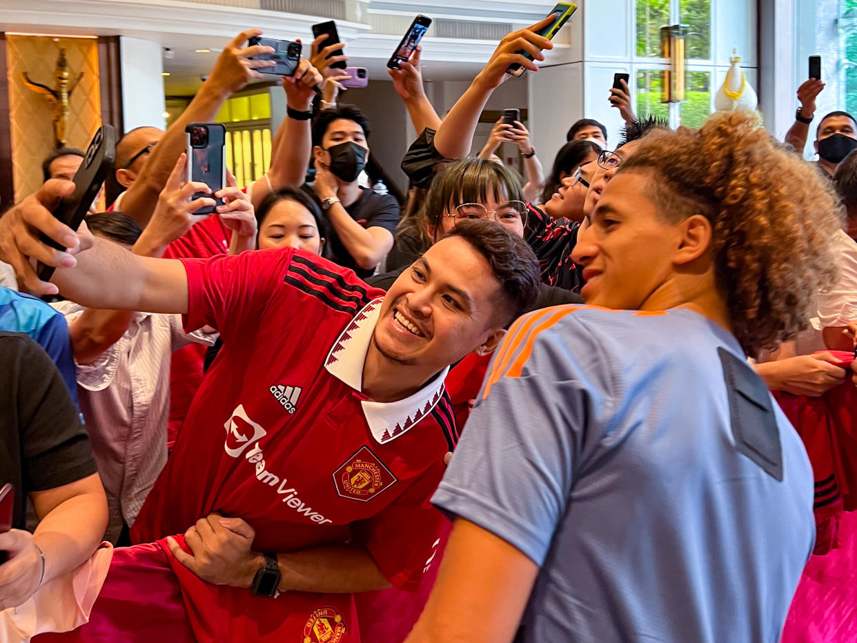 Manchester United's Hannibal Mejbri (right) poses with a fan ahead of a training session in Bangkok.