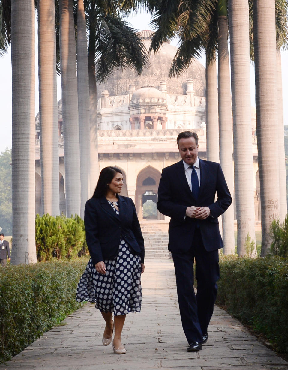 Prime Minister David Cameron speaks with Witham MP Priti Patel in front of the Shah Sayyid Tomb in the Lodi Gardens in Delhi, India.