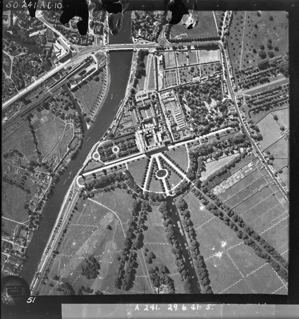 <p>Hampton Court Palace in 1941 with anti-aircraft obstructions made up of short sections of ditches and mounds of earth, designed to damage enemy aircraft if they tried to land in large open areas (Historic England / SWNS)</p> 