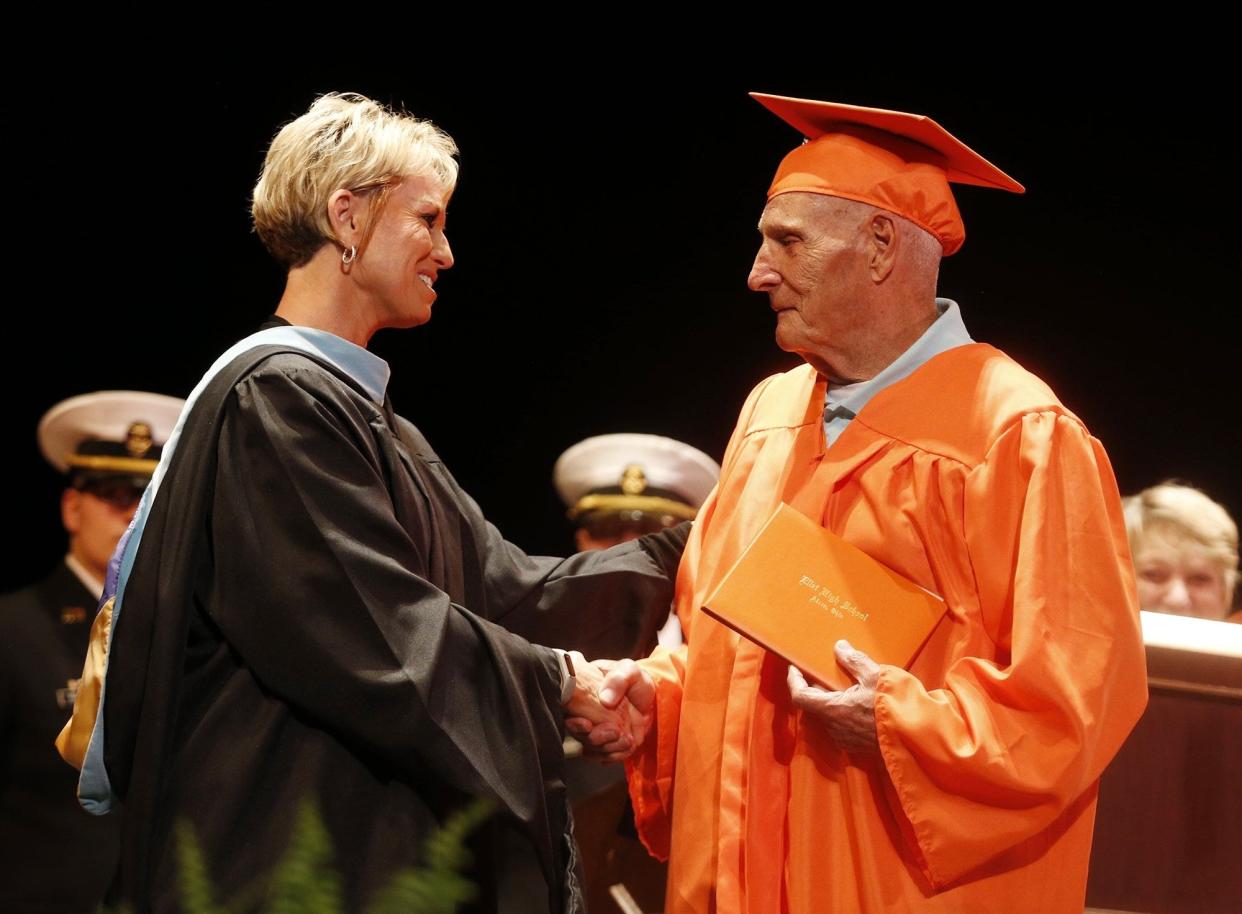 Floyd E. Hoskins, 87, receives his diploma from Michelle Marquess-Kearns during the Ellet High School graduation ceremony at the Akron Civic Theatre in 2019.