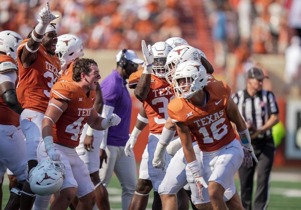 Texas Longhorns defense celebrate a turnover against Rice Owls in the third quarter of an NCAA college football game, Saturday, Sept. 2, 2023, in Austin, Texas.