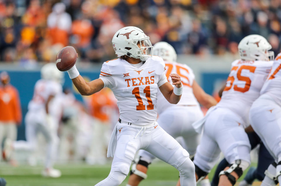 Nov 20, 2021; Morgantown, West Virginia; Texas Longhorns quarterback Casey Thompson (11) throws a pass during the second quarter against the West Virginia Mountaineers at Mountaineer Field at Milan Puskar Stadium. Ben Queen-USA TODAY Sports