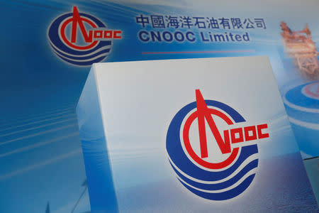 FILE PHOTO: Logos of China National Offshore Oil Corporation (CNOOC) are displayed at a news conference on the company's interim results in Hong Kong, China March 23, 2017. REUTERS/Bobby Yip/File Photo