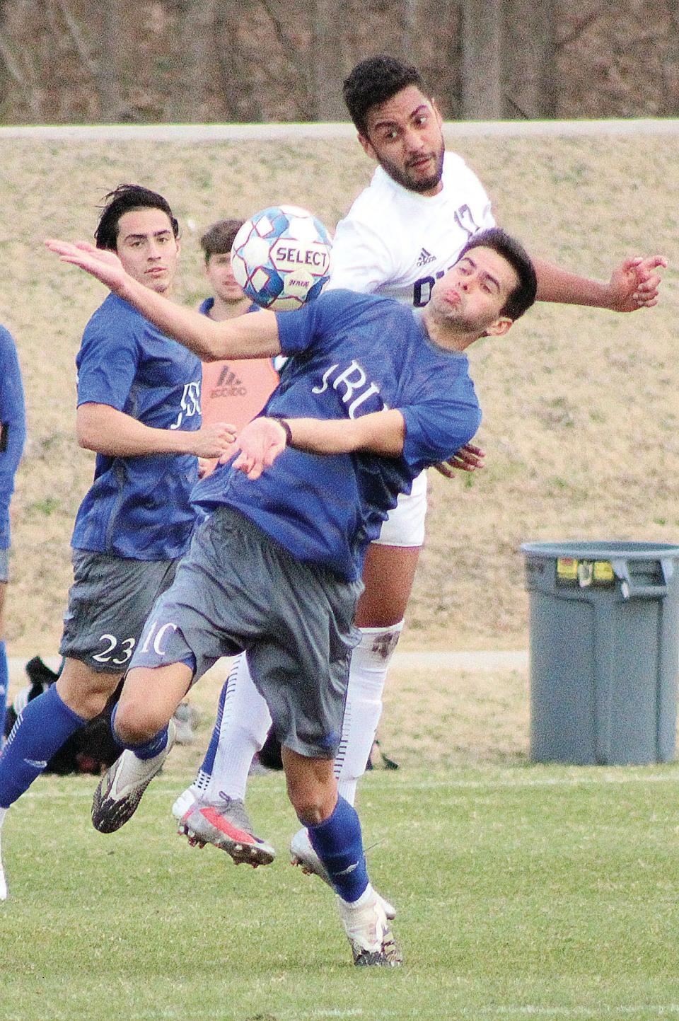 Oklahoma Wesleyan University's Alfeu Bertini, second from right, battles with a John Brown University player for ball possession during 2020 men's soccer season action.