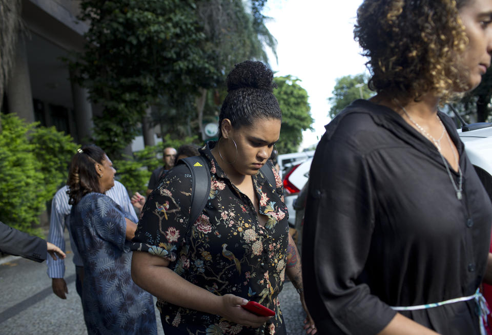 Anielle Franco, the sister of slain councilwoman Marielle Franco, right, and her daughter Luyara Santos, leave the Public Prosecution Office after attending a press conference, in Rio de Janeiro, Brazil, Tuesday, March 12, 2019. Police in Brazil have arrested two former policemen in the killing of the councilwoman and her driver. The brazen assassination of the two on March 14 last year led to massive protests and widespread anger in Latin America's largest nation. (AP Photo/Silvia Izquierdo)