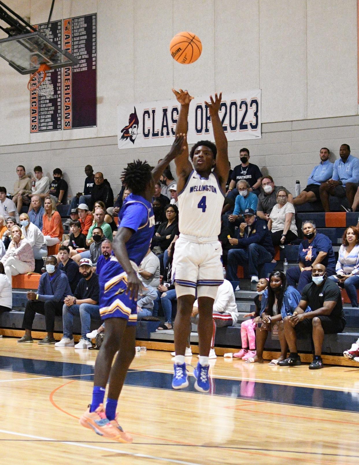 Wellington sophomore Reggie Reinhardt takes a shot from outside the paint during Tuesday's Holiday Basketball Classic against Cardinal Newman. The Wolverines won the game, 74-62.